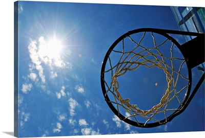 Basketball Hoop and the Sun, against blue sky