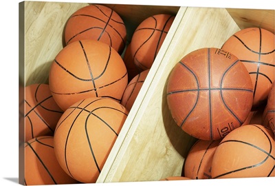 Basketballs in storage bin