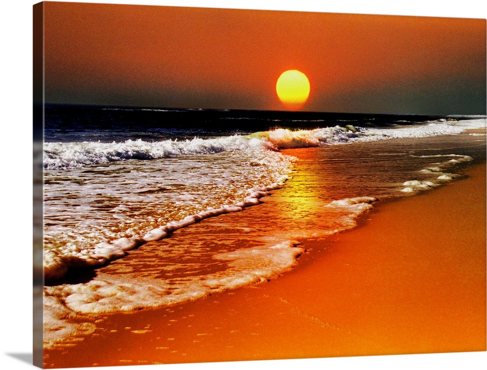 This canvas wall art is a photograph of the sun dropping below the horizon in this landscape at the sea.