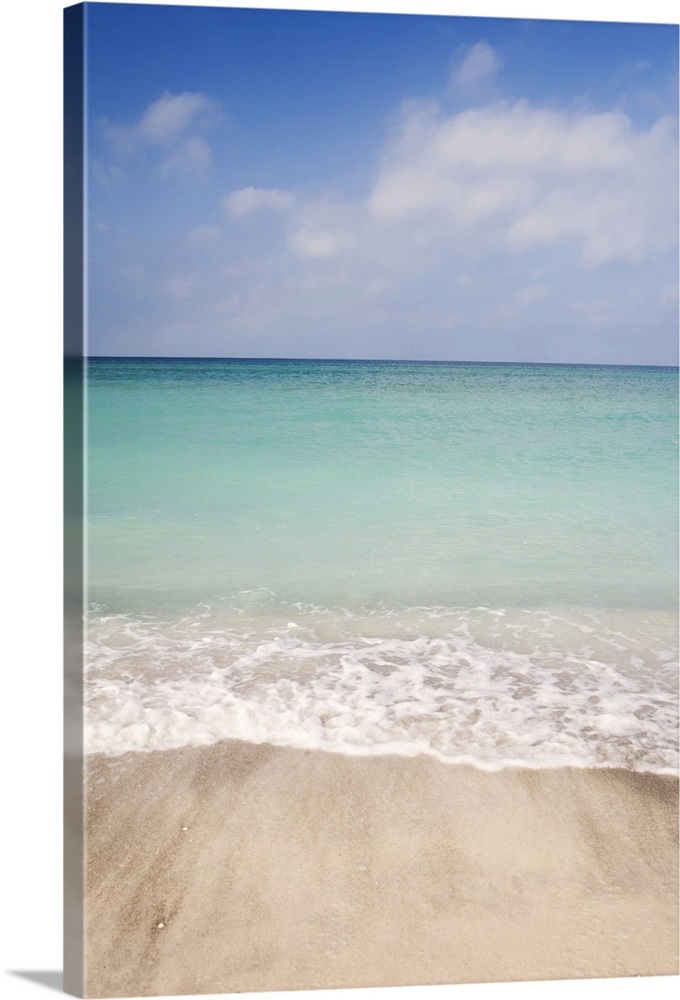 Beach scene with blue sky, turquoise water and white sand. Sarasota
