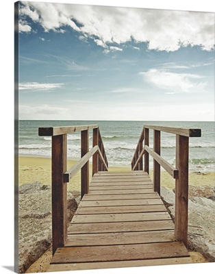 Beach with wooden pier in Spain.