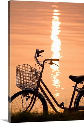 Bicycle in sunshine beside water. Otsu, Shiga Prefecture, Japan