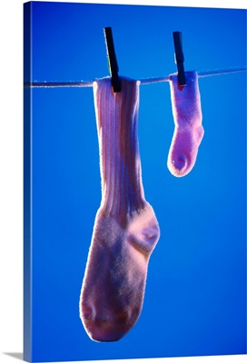 Big and small socks on clothesline