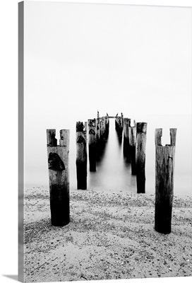 Black and white long exposure shot of Cormorants sitting on a derelict pier.