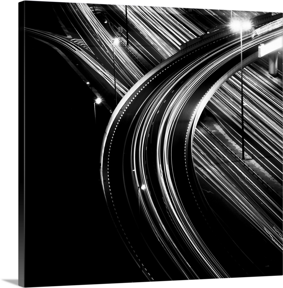 Black and white shot of multiple light trails of an overpass in Dubai city.