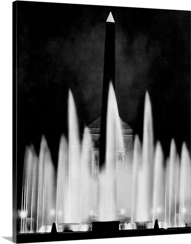 A black marble obelisk rises above a water fountain that is equipped with 40 General Electric underwater projectors at the...