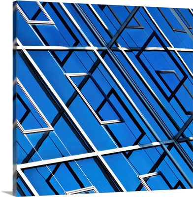 Blue, abstract and geometric reflection on  facade of modern building.