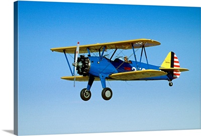 Blue Stearman 9046V Bi-Plane Flying In Blue Sky