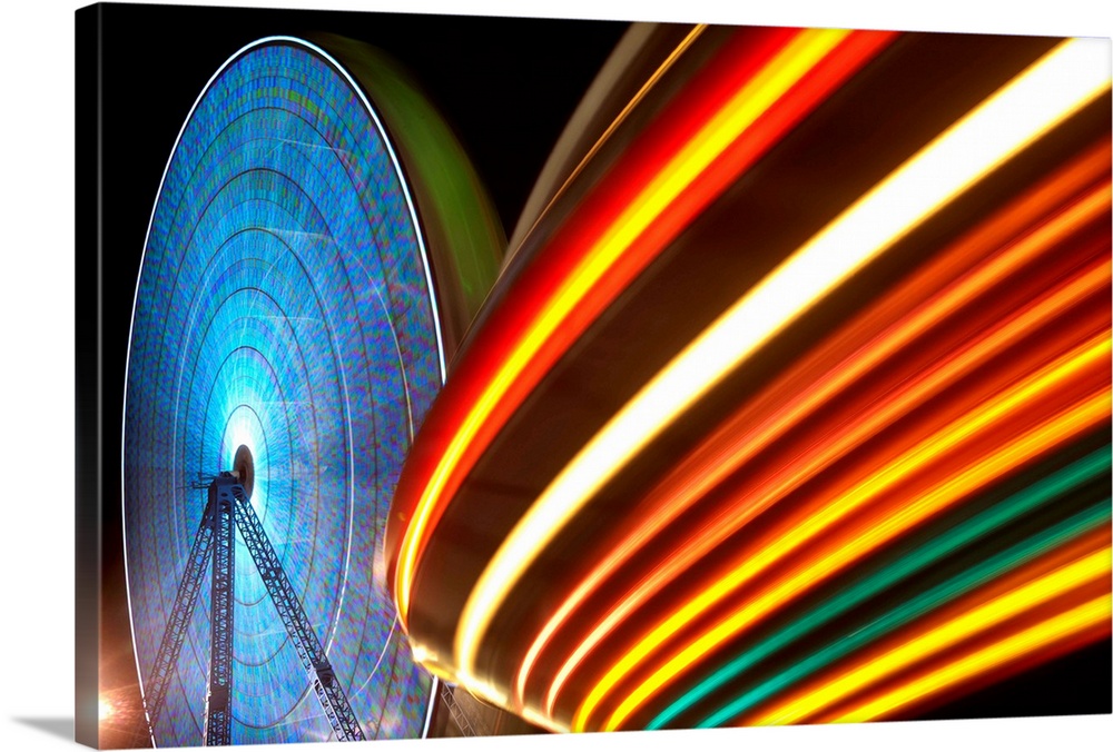 USA, New Jersey, Seaside Park, Light trails from ferris wheel and rides Boardwalk amusement park lights at night at Funtow...