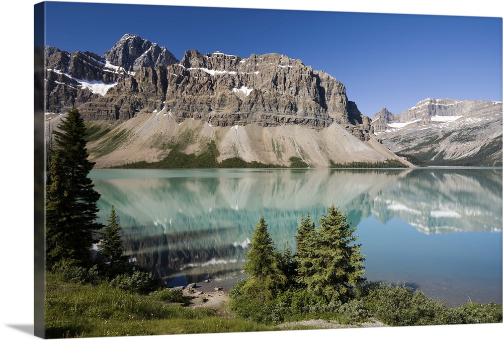 Canadian Rocky Mountains reflected in Bow Lake, a popular scenic stop on the Icefields Parkway in Banff National Park, Alb...