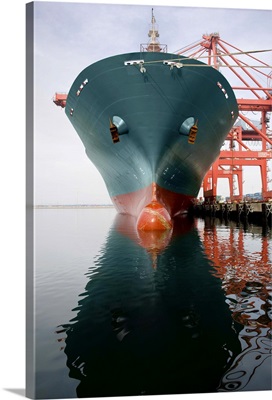 Bow of a red and teal cargo ship.