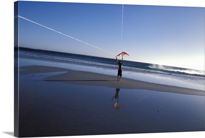 Boy flying kite at beach