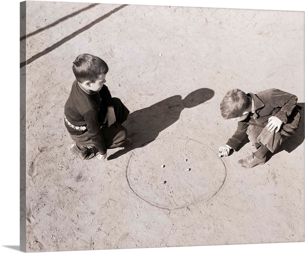 Overhead view of two young boys playing marbles. Undated photograph.