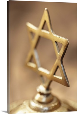 Brass Jewish cross on brown background