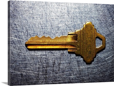 Brass key on stainless steel.