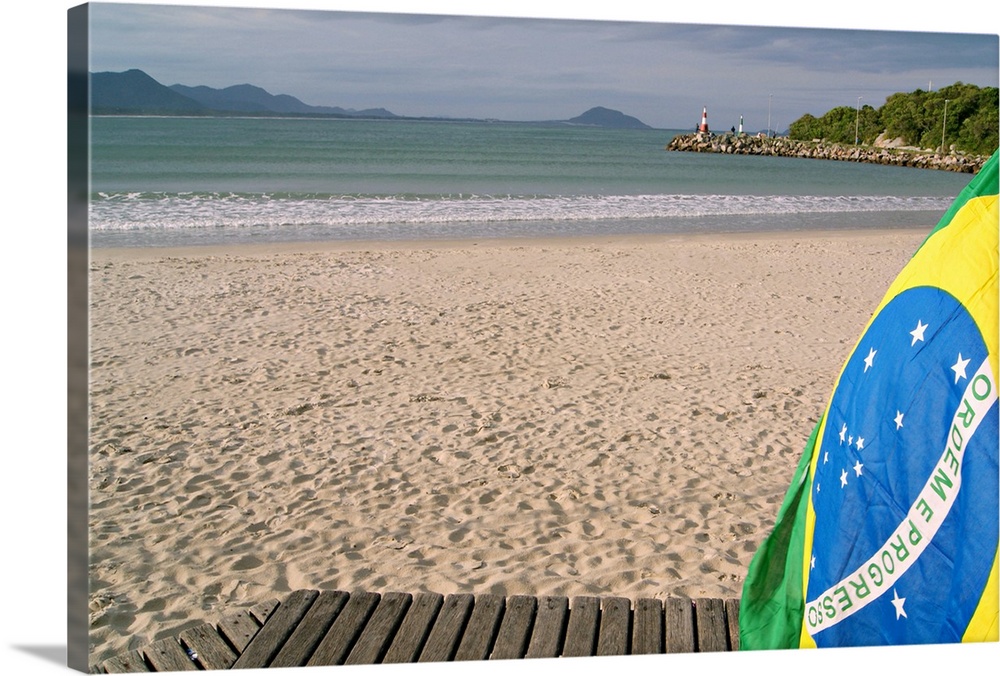 Close-up of Brazil flag on beach sand.