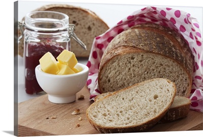 Bread, butter and jam on chopping board