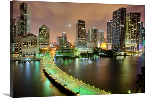 Bridge leads across waterway to downtown Miami sklyine at night ...