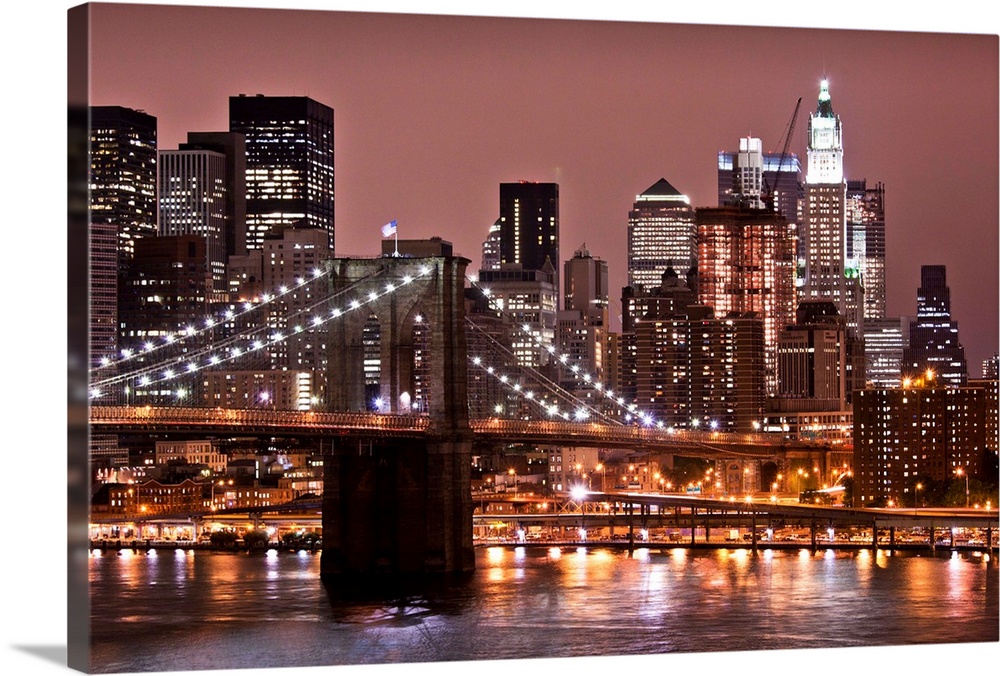USA, New York, Brooklyn, Brooklyn Bridge at night and East River with Lower Manhattan skyline glowing in distance