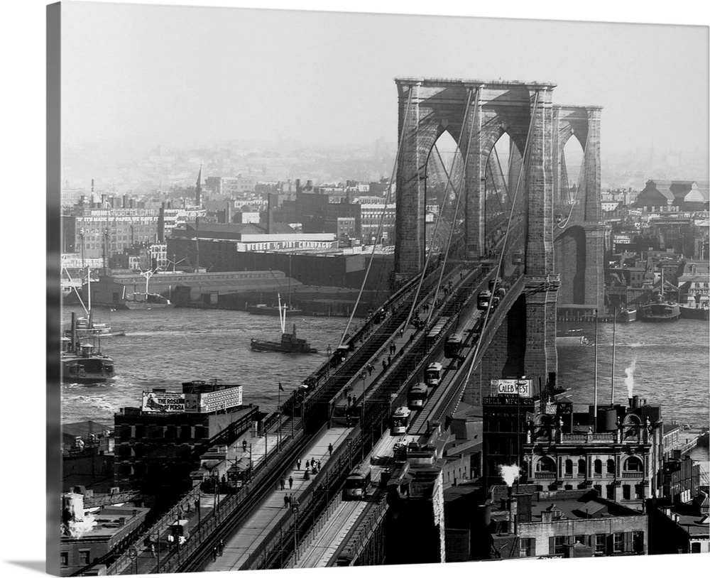 A walkway, train track and carriage drive span the Brooklyn Bridge, the largest suspension bridge at the time of its compl...