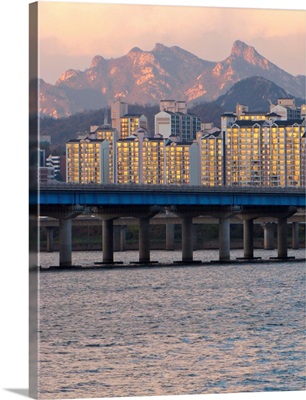 Buildings and Mount Bukhan by Han river in Seoul, South Korea.