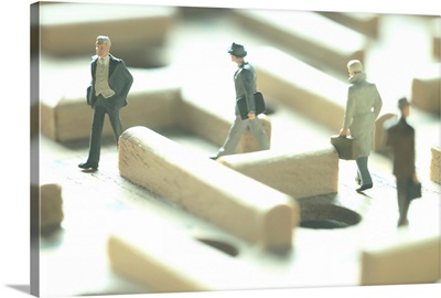 Businessmen figurines in a maze game