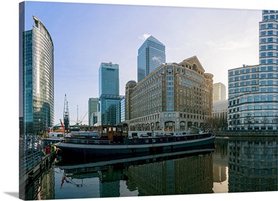 Canary Wharf and barges in early morning light