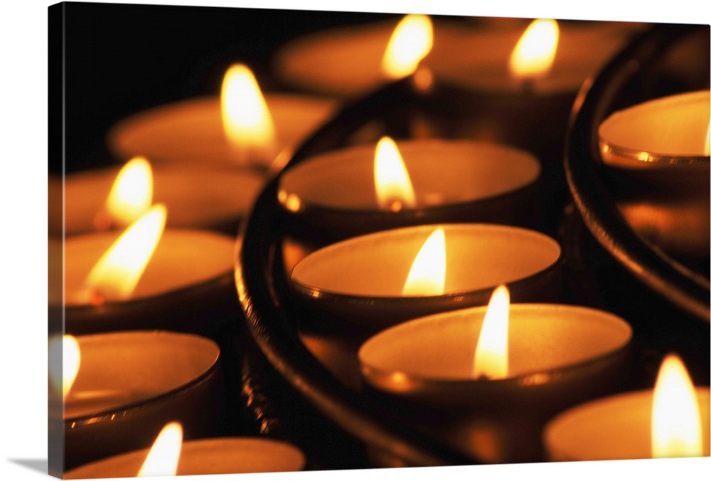 Candles lighted in candle holders in 'Notre Dame' cathedral