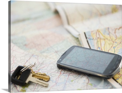 Car keys and smartphone on map