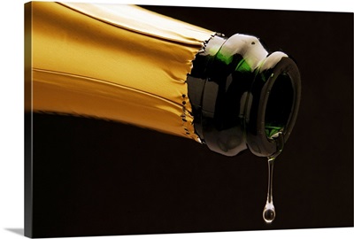 Champagne drop dripping from bottle
