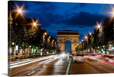 Champs Elysees and Arc de Triomphe at dusk.