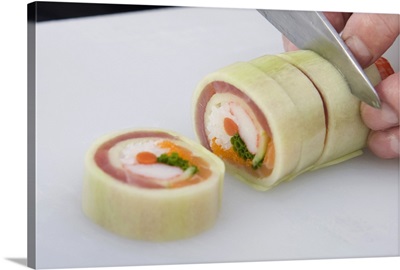 Chef slicing sushi roll