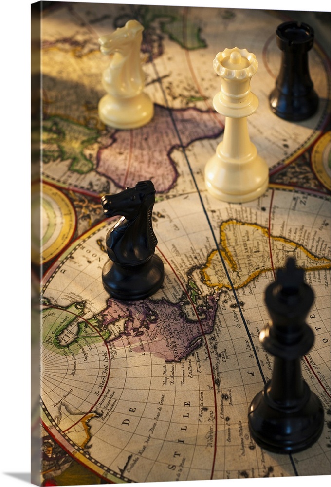 Chess pieces on old world map