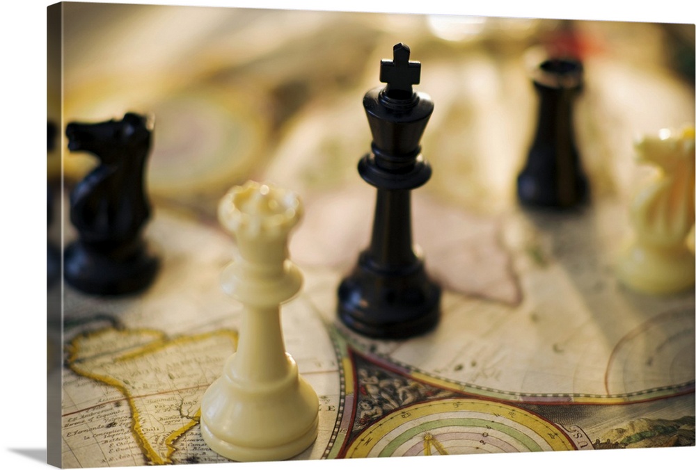 Chess pieces on old world map