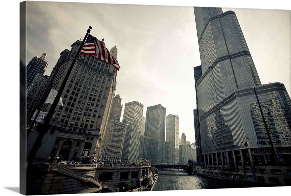 The sun rises over the glorious Chicago river. The American flag is seen braving waving in the foreground. An overall esse...