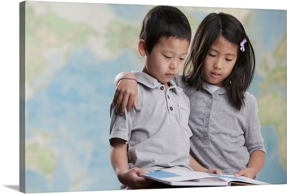 Korean children reading book near map