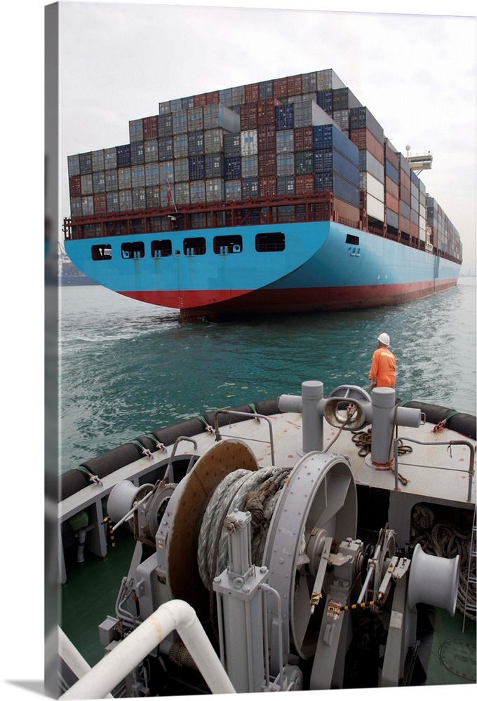 China, Hong Kong Harbor, tugboat sailor waiting to give mooring line to container ship