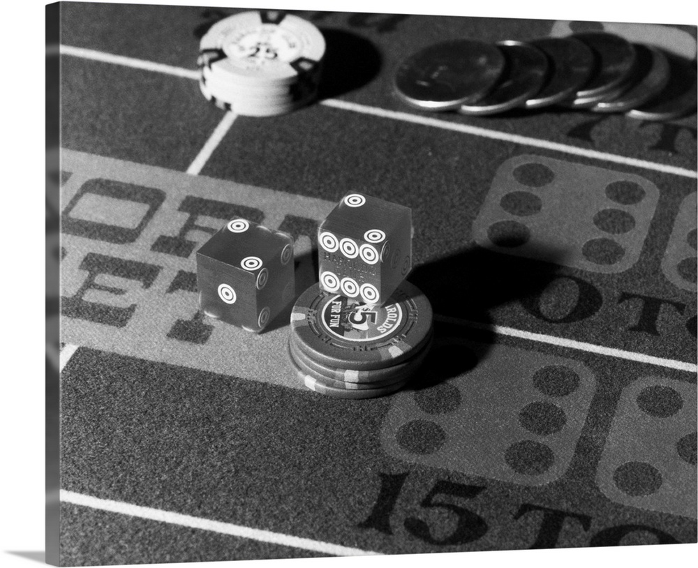 Photo shows a close-up of chips, coins and dice on a gambling table in a casino. The dice have Harold's Club engraved on t...