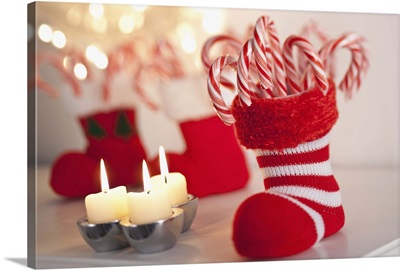 Christmas candy cane in stocking with candles