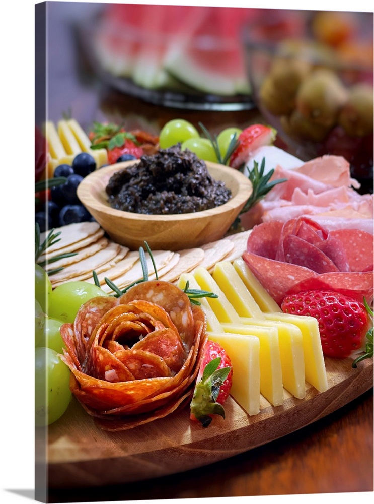 Christmas charcuterie festive cheese board. Fresh cheddar cheese, wide mix of fresh fruits with grapes, strawberries, blue...