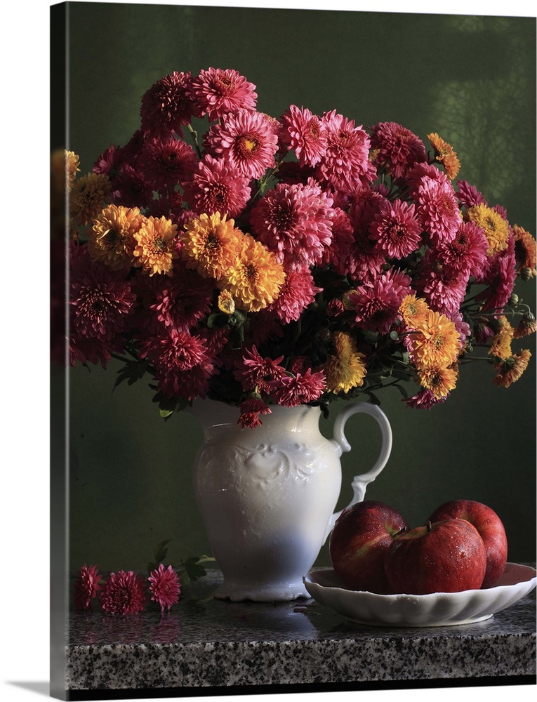 Chrysanthemums flowers in vase with red apples in plate.