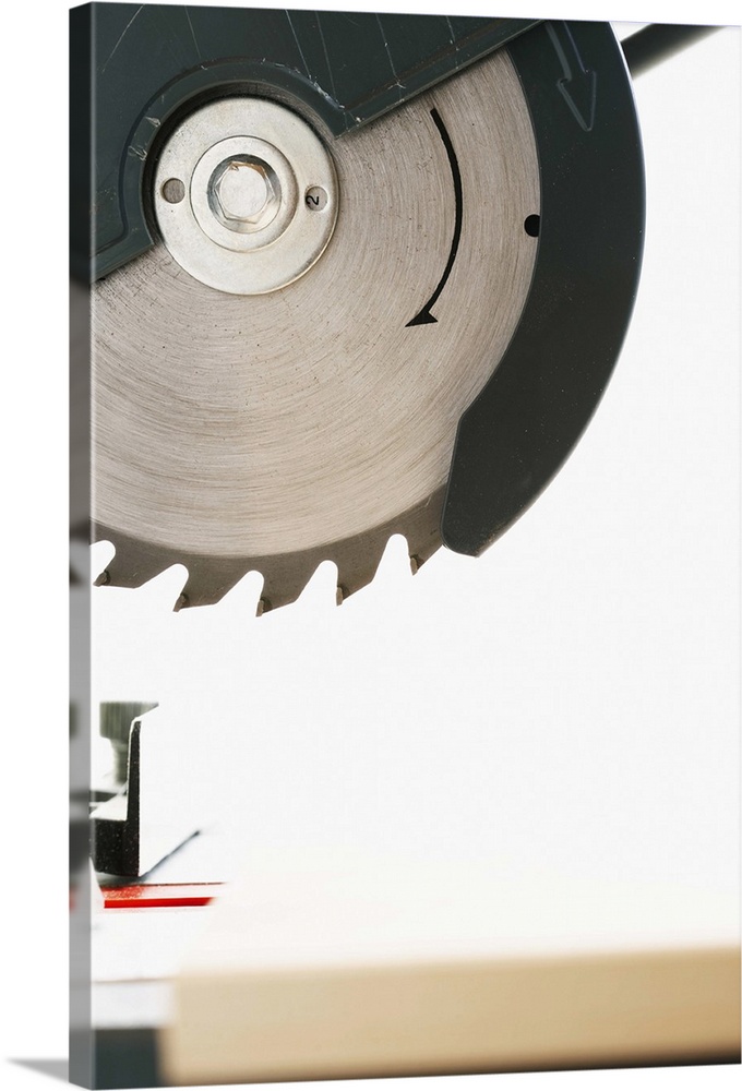 Circular saw above wooden board, close-up