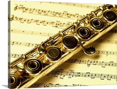 Close-up of a flute on a sheet music