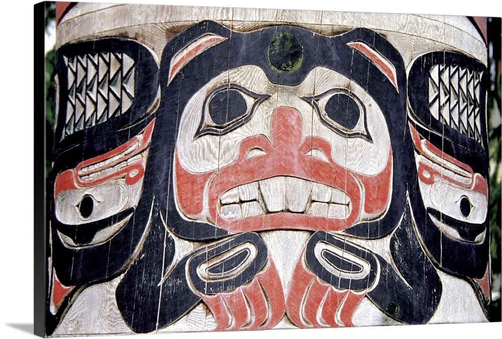 Close-up of a painted face on Totem Pole, Ketchikan, Alaska, USA.