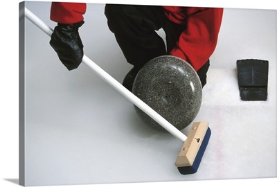 Close-up of a person holding a curling stone