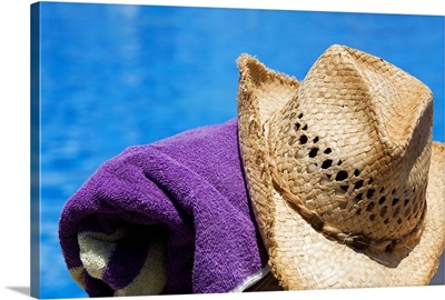 Close-up of a straw hat with a towel at the poolside, Cancun, Mexico