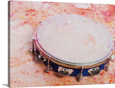Close-up of a tambourine with Holi colors