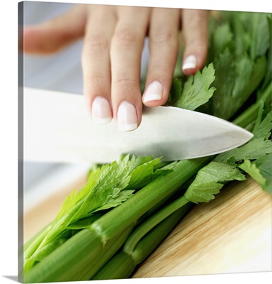 Close-up of a woman's hand chopping celery