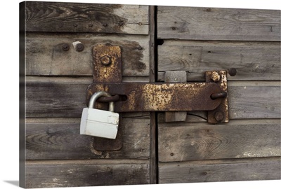 Close-up of a wooden door with a padlock
