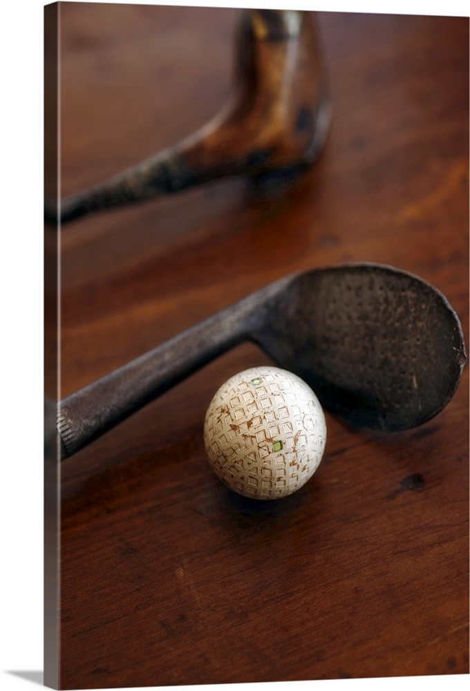 Close up of antique golf clubs and golf ball